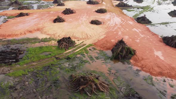 Aerial dolly move over red clay soil oil fill the land clear alt