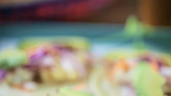 Fresh fish tacos with cod and purple cabbage on a white corn tortillas. alt