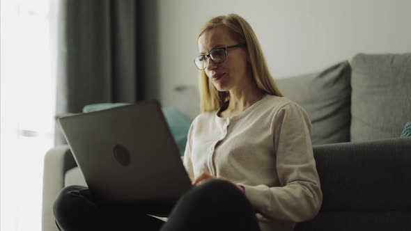 Woman on Floor with Laptop alt