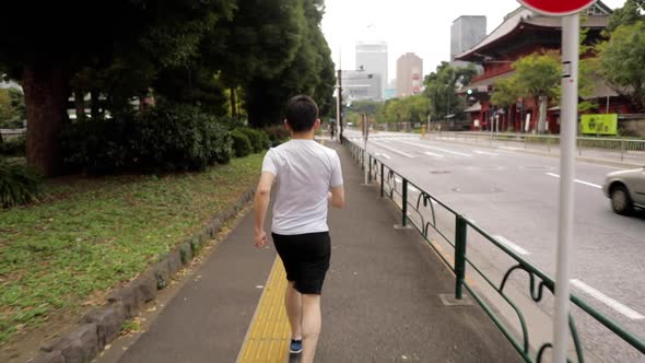 Middle-aged Japanese man exercises in Tokyo Japan alt