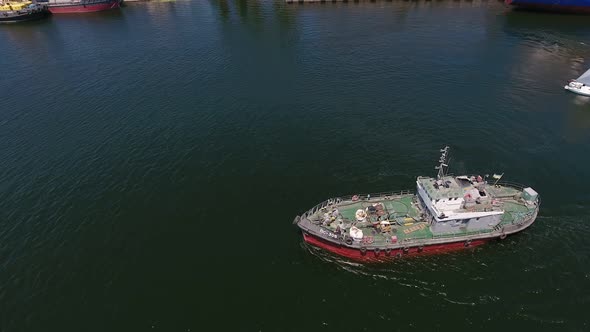 Aerial Shot of a Small Tugboat Going in the Dnipro on a Sunny Day in Summer 