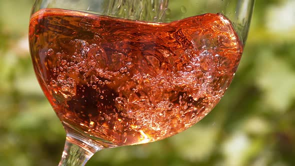 Pink Wine being poured into Glass, Slow motion