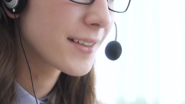 Closeup of the Face of a Young Girl Wearing Headphones Who Communicates Online Explains Teaches alt
