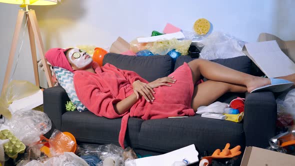 Woman in The Bathrobe Lying on The Sofa