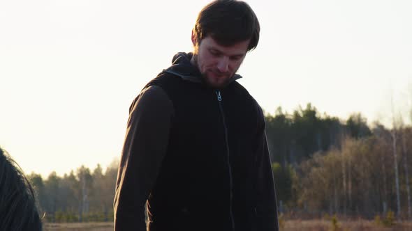 A Man Stands Next to a Horse Closeup alt