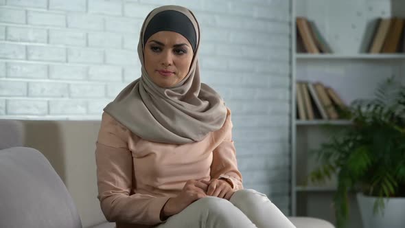Upset Arabic Woman Sitting at Home Sofa, Feeling Hurt and Disappointed, Crisis alt