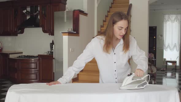 Pretty Caucasian Young Woman Dancing While Doing Housework at Home alt