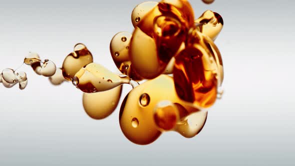 Orange Golden Lubricant Oil in Zero Gravity in Vertical Video Framing