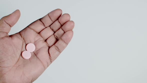Two Antacid Pills In Hand alt