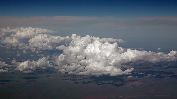 Airplane View of Partly Cloudy and Cumulus Clouds Condensed in Clusters in Humid Warm Air alt