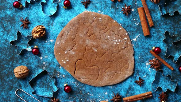 Christmas Baking Concept. Gingerbread Dough with Different Cutter Shapes alt
