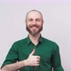 Happy bearded man showing thumbs up sign over white background. Good job. - VideoHive Item for Sale