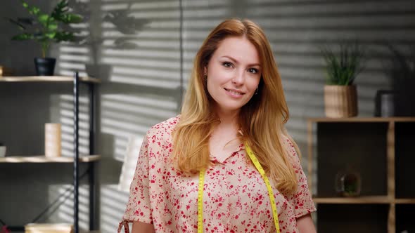 Portrait of Attractive Happy Female Creative Clothing Designer Standing in Modern Office alt