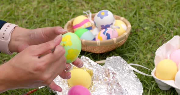 Drawing on egg for Easter holiday at outdoor alt