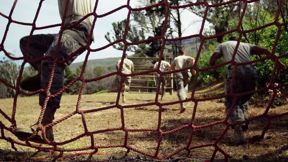 Military troops running during obstacle course 4k alt