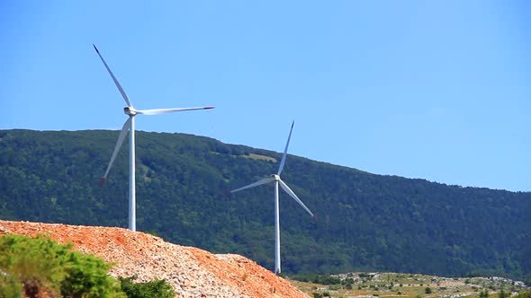 Pair of Big Wind Turbines Rotating and Generating Electricity