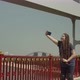 Female Taking Selfie While Rollerskating on Bridge - VideoHive Item for Sale