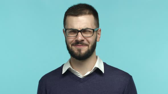 Slow Motion of Handsome Adult Man with Beard Wearing Glasses Shaking Head and Grimacing From