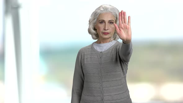 Senior Woman Making Gesture STOP with Hand. alt