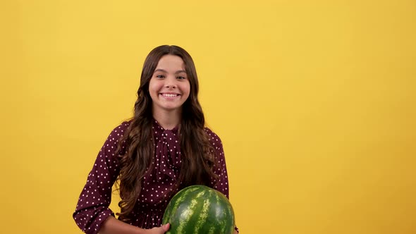 Happy Kid with Watermelon Fruit on Yellow Background Fruit