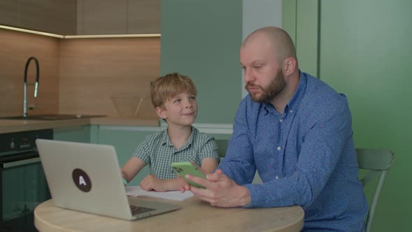 Kid Asking Father for Help with Online Homework alt