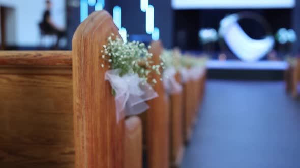 benches in the church are decorated with flowers for the wedding ceremony