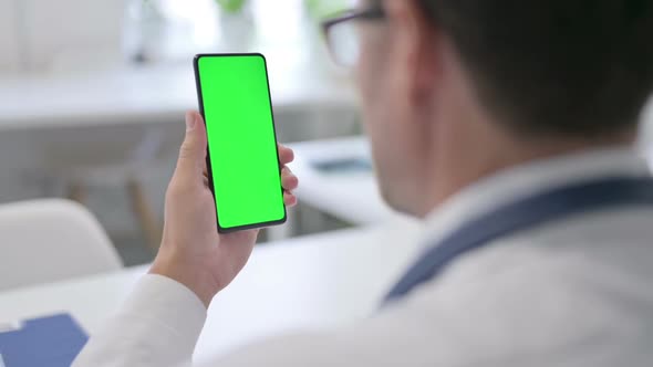 Doctor Holding Smartphone with Green Chroma Key Screen alt