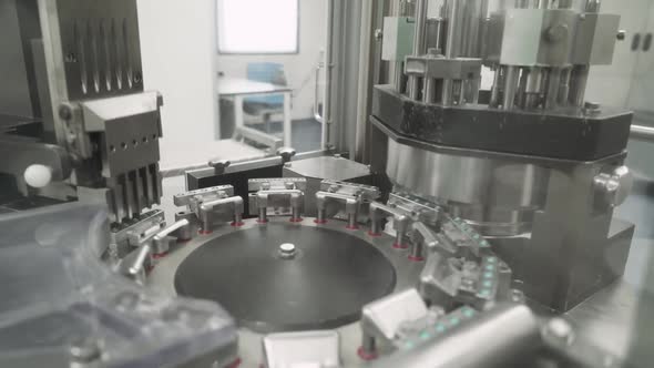 Production of Pharmaceuticals and Drugs Large Number of Capsules in Motion White Tablets on the alt