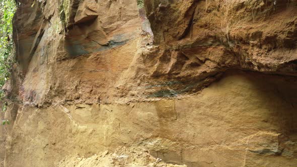 Aerial view showing the many layers of colored earth visible in a large clay cliff alt