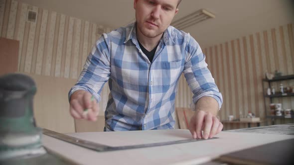 Carpenter Makes Pencil Markings on the Blank with the Help of a Ruler
