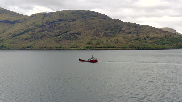 A Commercial Vessel Traversing A Sea Lake From The Air alt