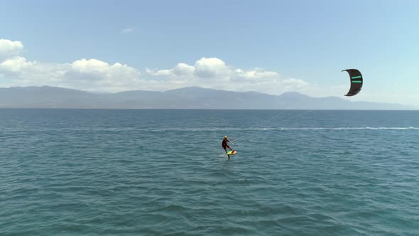 Aerial view of person kitesurfing in the Gulf of Patras, Greece. alt