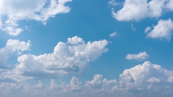 Clouds Move Rapidly Against a Blue Sky on a Bright Sunny Day. Swirling Snow-white Clouds Against the alt