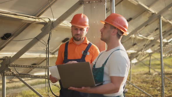 Engineer Man Inspects Construction of Solar Cell Panel or Photovoltaic Cell By alt