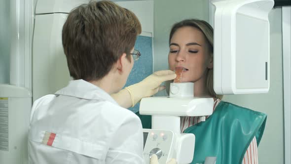Attractive Young Girl Doing Examination of Teeth By Using Panoramic and Cephalometric X-Ray Scanner alt