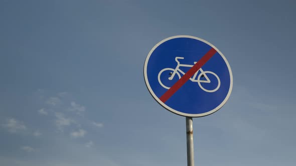 "no cycling" sign against blue sky. No cyclists' travel sign. "No bicycles" sign. alt