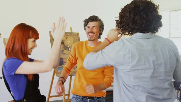 Artists giving high five to each other 4k alt