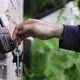 Closeup of a Caucasian Man&#39;s Hand Opens Old Padlock That is Hanging - VideoHive Item for Sale
