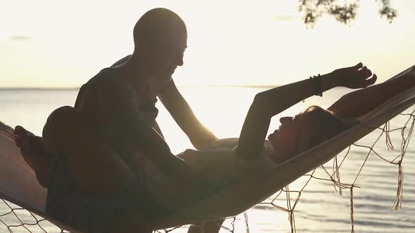 couple hugging in the hammock. 