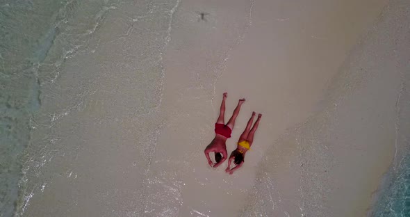 Happy people in love dating on vacation enjoy luxury on beach on clean white sand 4K background alt