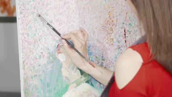 Cropped Rear View Shot of a Female Artist Painting at Art Studio