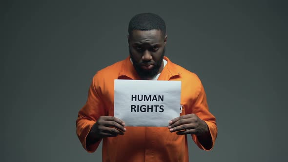 Afro-American Prisoner Holding Human Rights Sign, Ill Treatment, Awareness alt