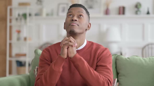 Portrait of African Man Praying with Fingers Crossed alt