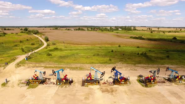 Aerial view of the row of oil derricks in summer alt