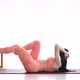 Fitness woman doing abs crunches exercise lying flat on floor training at home. - VideoHive Item for Sale