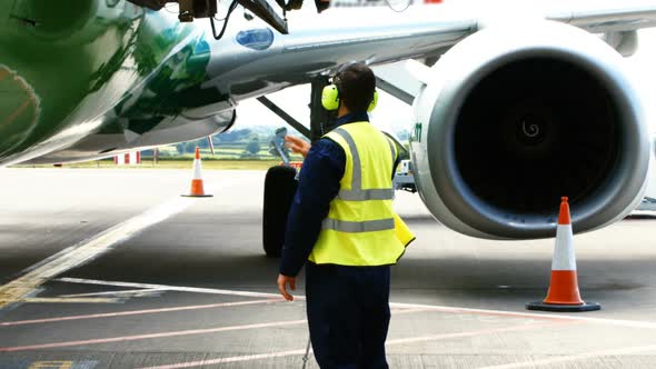 Aircraft marshaller giving direction alt