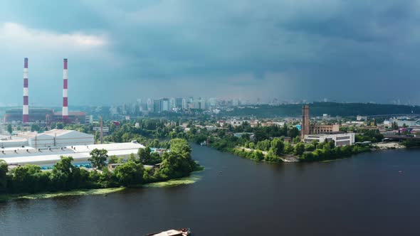 Aerial View of Industrial Factories and River Tugboat Towing Barge alt