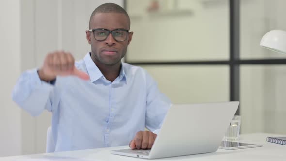 Thumbs Down By African Man with Laptop alt