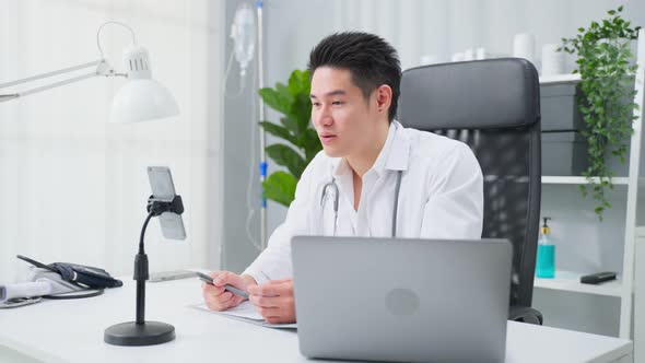 Asian male medical doctor talking virtual online with patient at home. alt