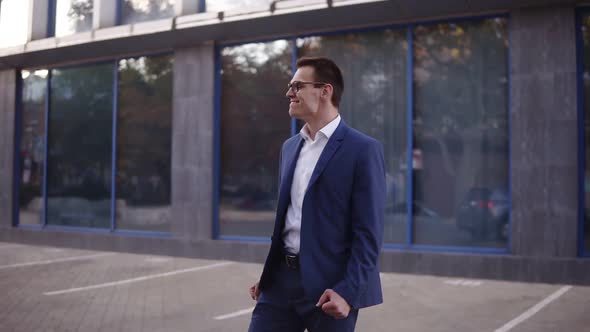 Young Businessman Looking Around to Sure Noone See Him and Starts to Express His Feeling About alt